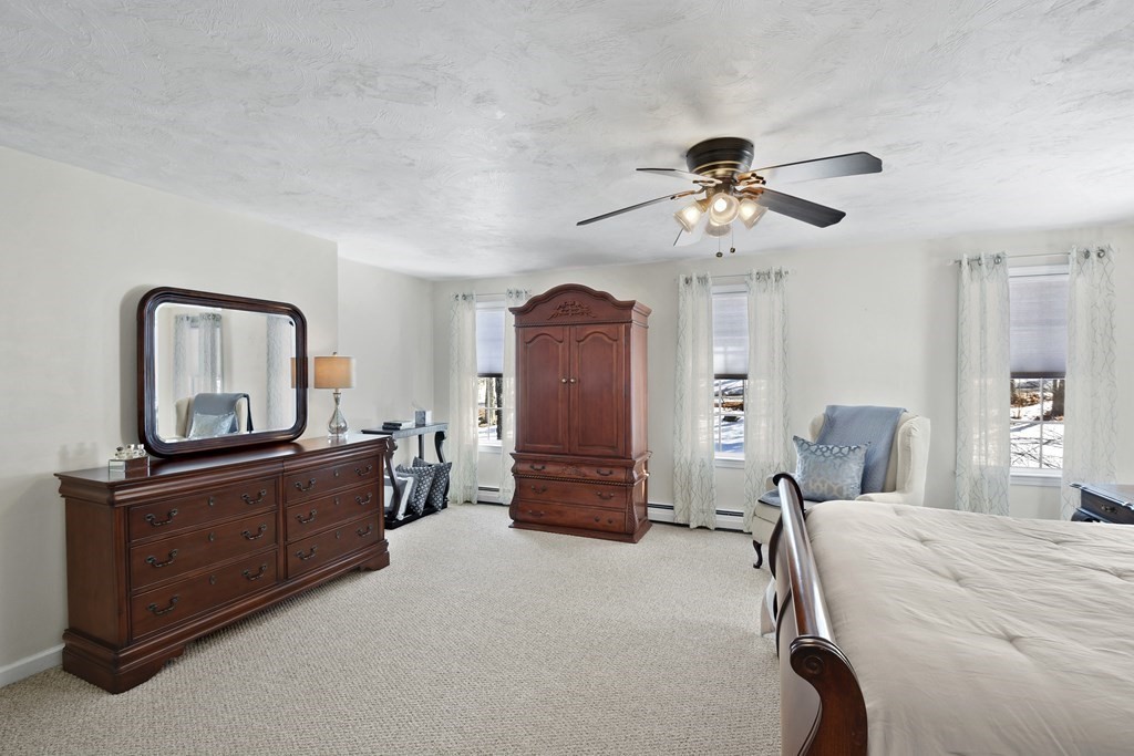 54 Carroll Hill Road Charlton, MA 01507 - Photo 17 of 30 a bedroom with a bed and furniture with mirror