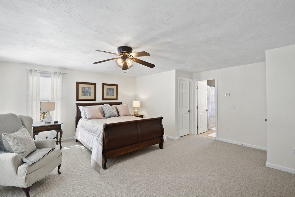 54 Carroll Hill Road Charlton, MA 01507 - Photo 18 of 30 a spacious bedroom with a bed couch and window