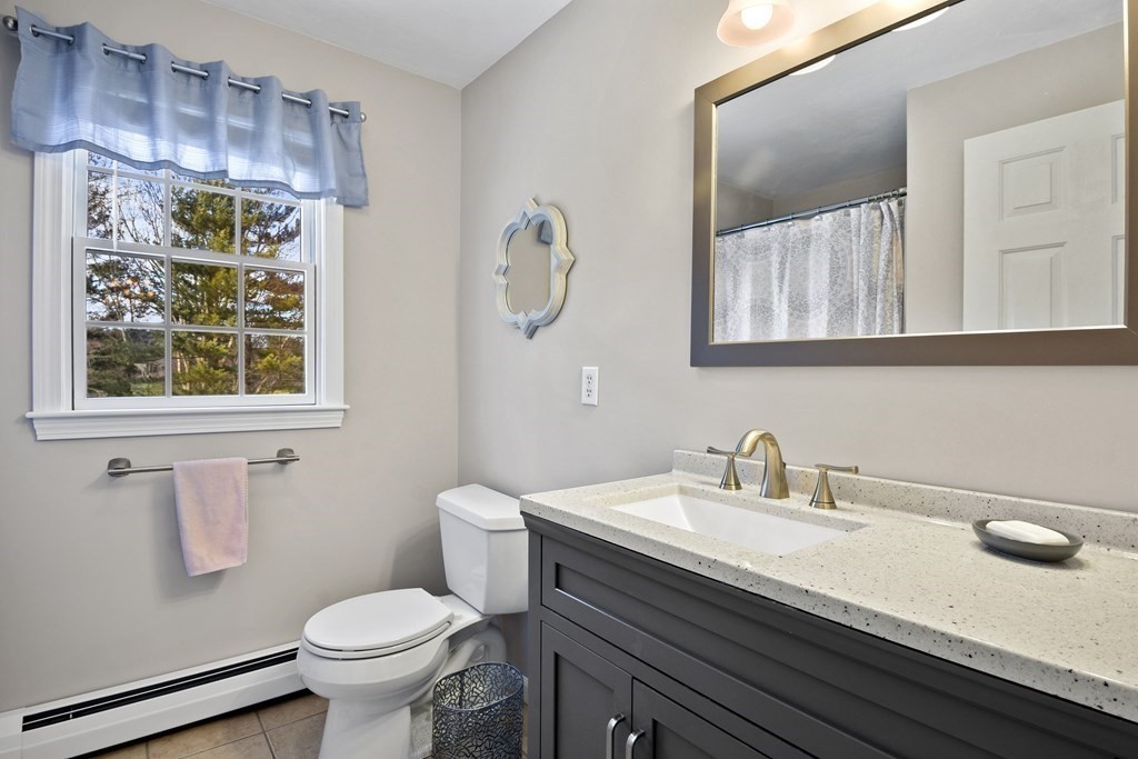 54 Carroll Hill Road Charlton, MA 01507 - Photo 19 of 30 a bathroom with a sink a toilet and mirror