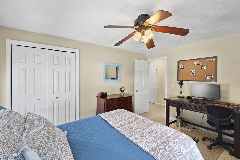 54 Carroll Hill Road Charlton, MA 01507 - Photo 21 of 30 a bedroom with a bed and a chandelier