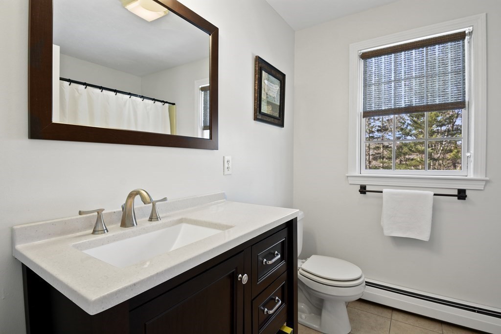 54 Carroll Hill Road Charlton, MA 01507 - Photo 24 of 30 a bathroom with a sink vanity and a toilet
