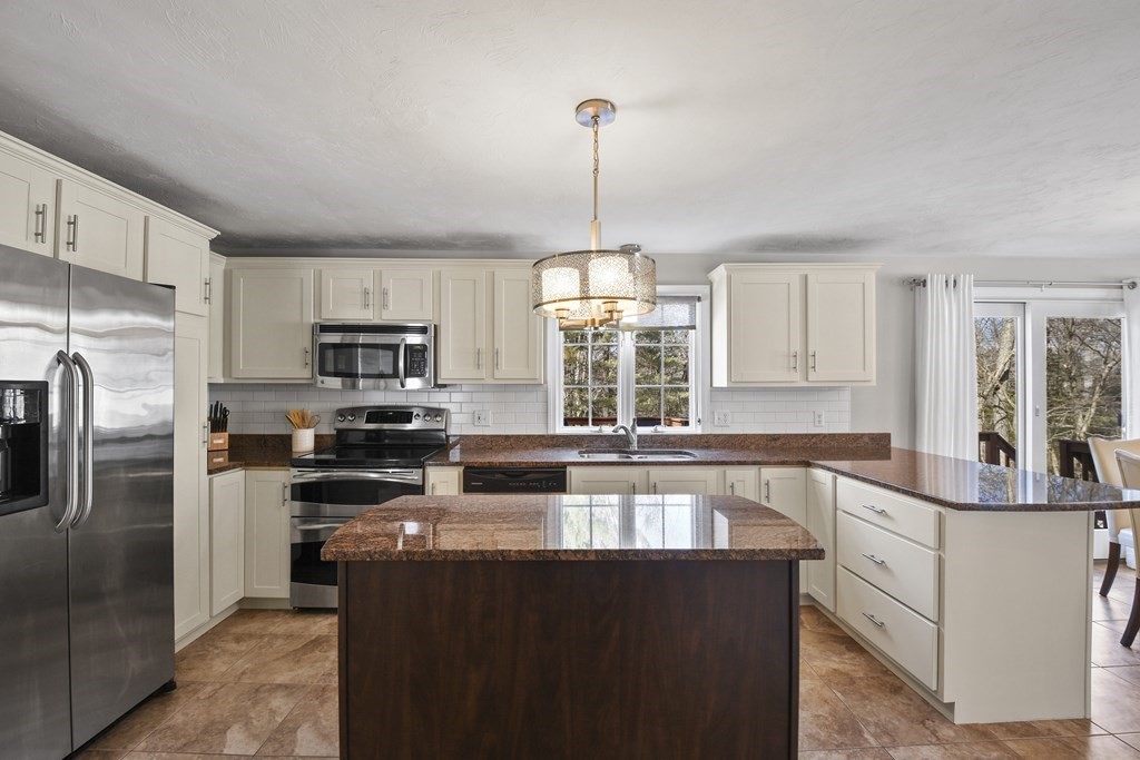 54 Carroll Hill Road Charlton, MA 01507 - Photo 6 of 30 a kitchen with stainless steel appliances granite countertop a sink a stove a refrigerator cabinets and a kitchen island