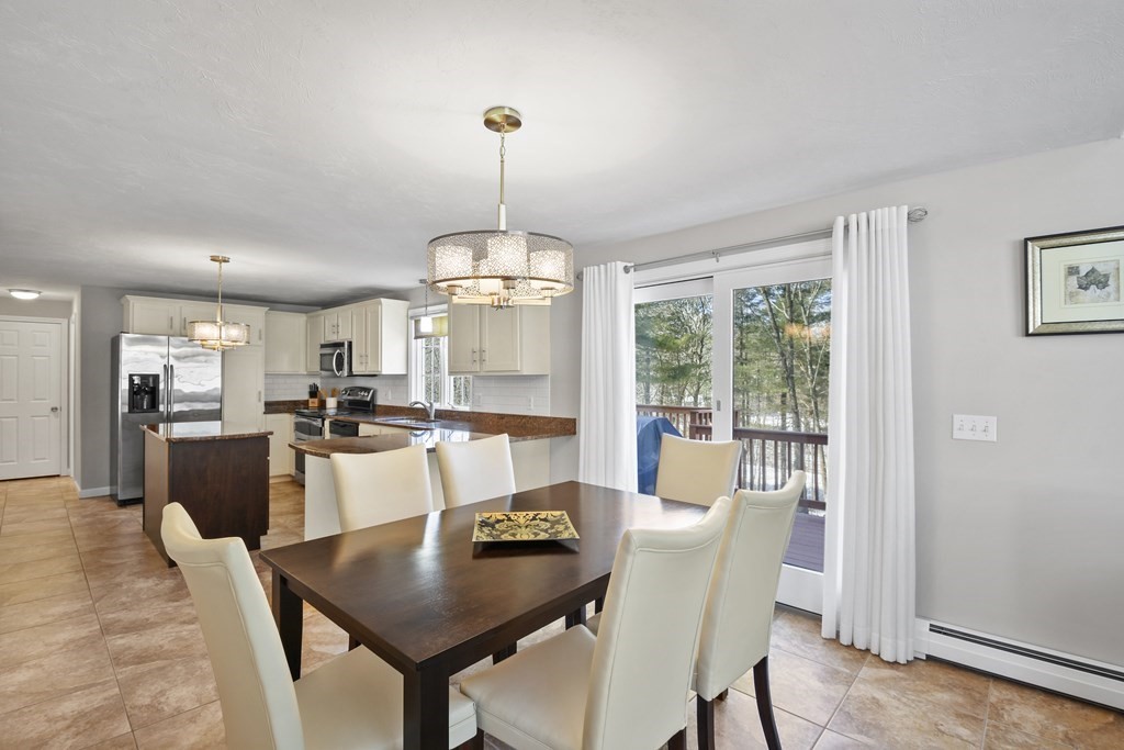 54 Carroll Hill Road Charlton, MA 01507 - Photo 8 of 30 a view of a dining room with furniture wooden floor and chandelier