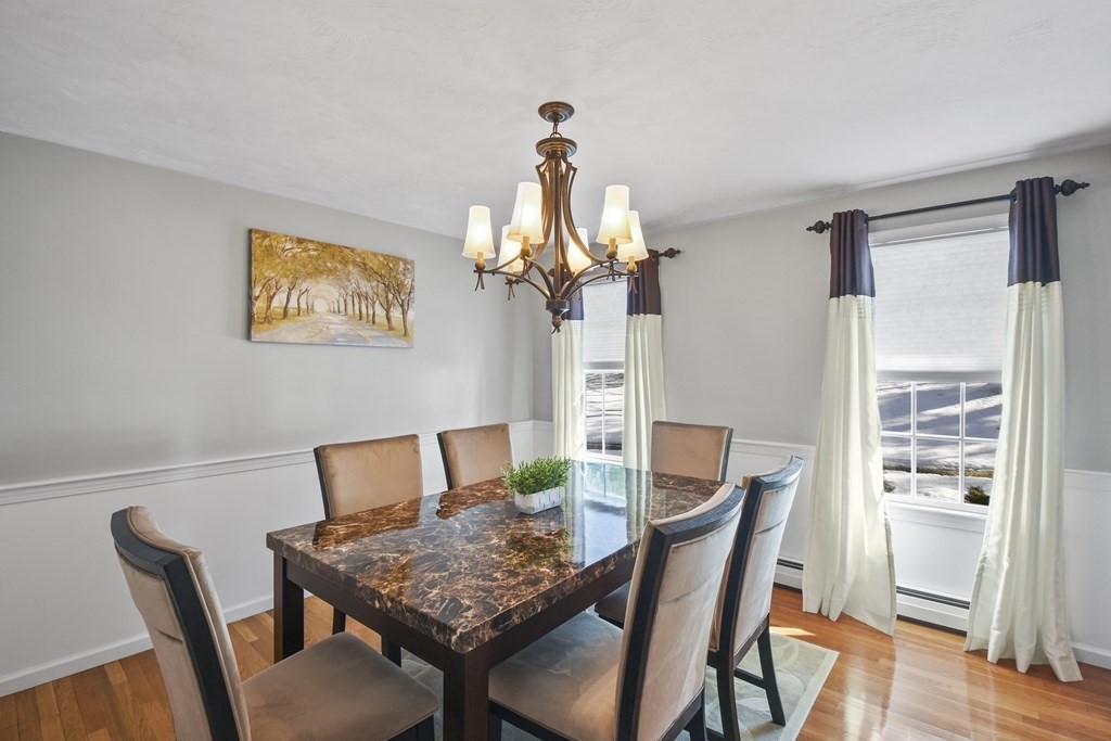 54 Carroll Hill Road Charlton, MA 01507 - Photo 10 of 30 a view of a dining room with furniture wooden floor and a chandelier