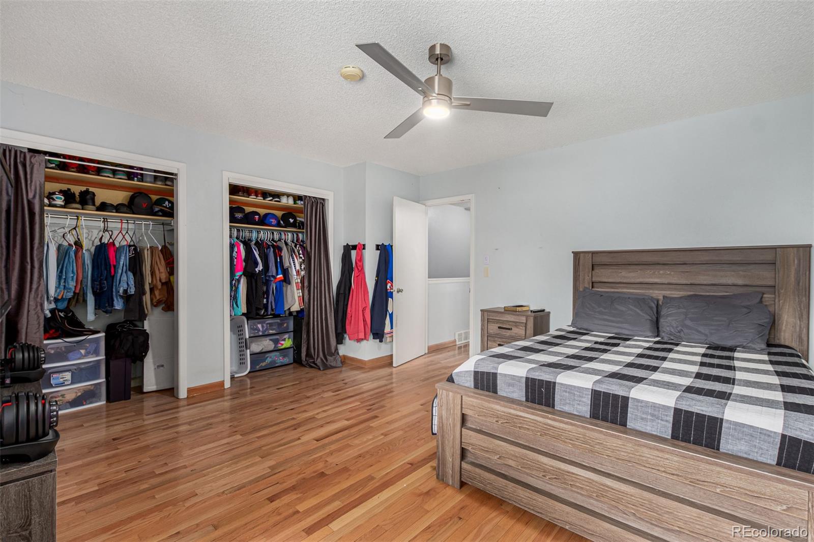 8140 West 90th Avenue Westminster, CO 80021 - Photo 18 of 47 a bedroom with a bed and a ceiling fan