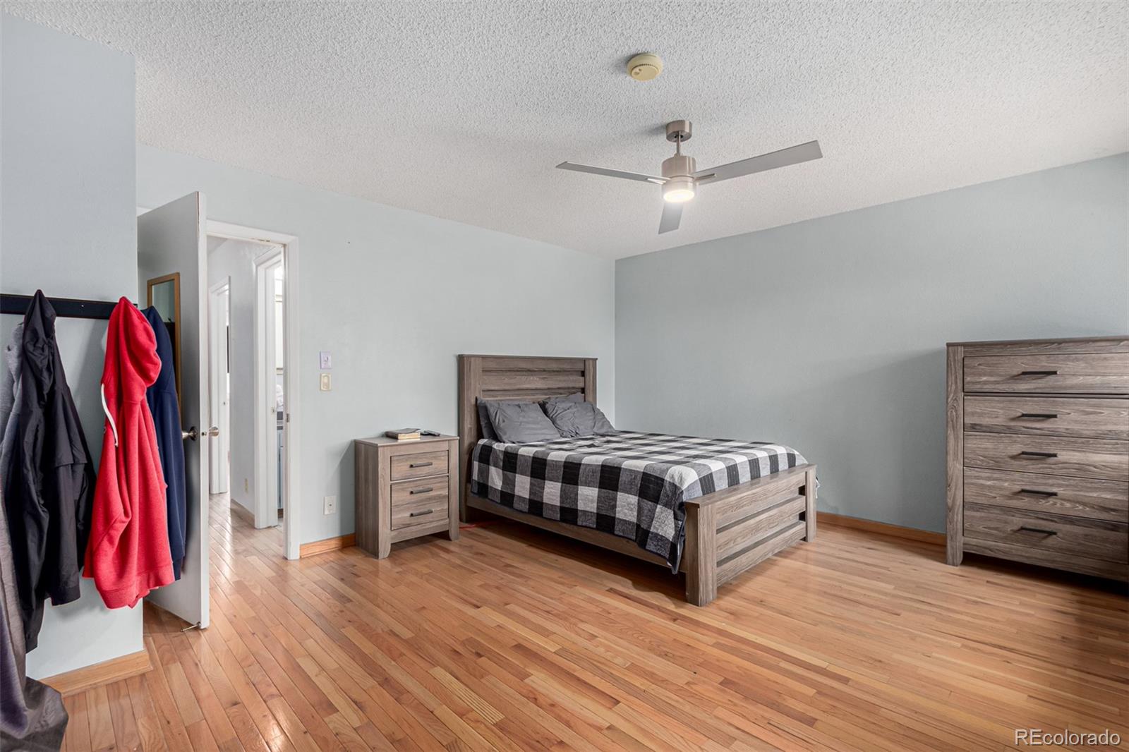 8140 West 90th Avenue Westminster, CO 80021 - Photo 19 of 47 a spacious bedroom with a bed and a walk in closet