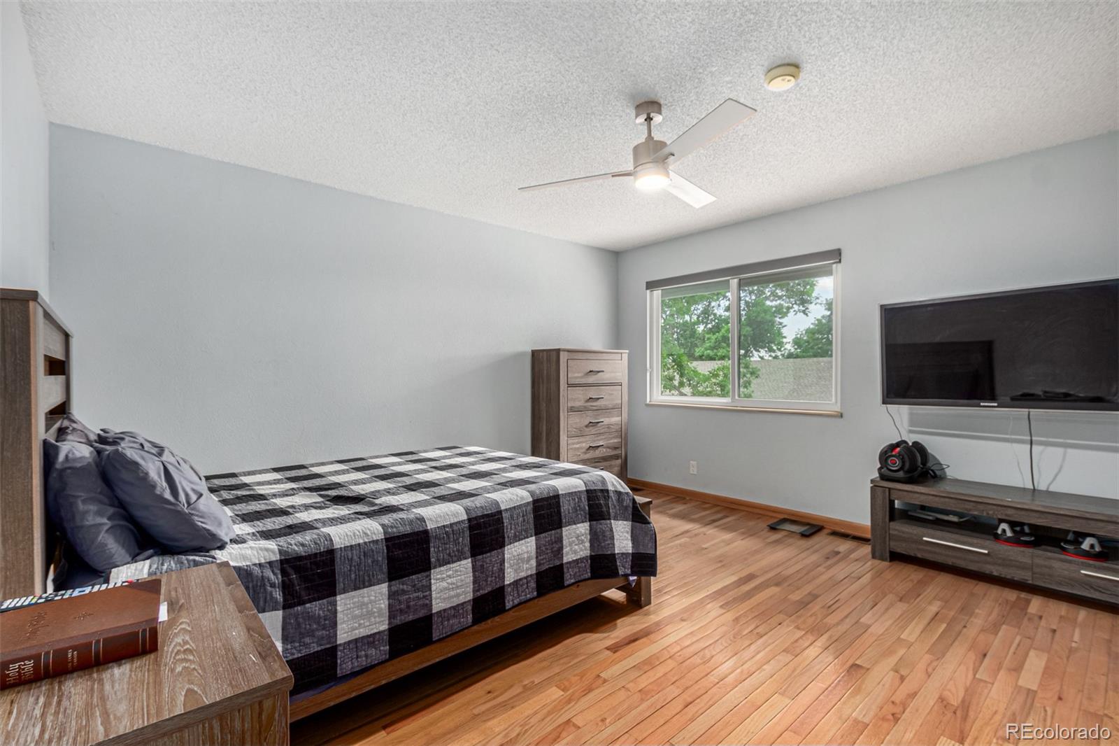 8140 West 90th Avenue Westminster, CO 80021 - Photo 20 of 47 a bedroom with a bed and a flat screen tv