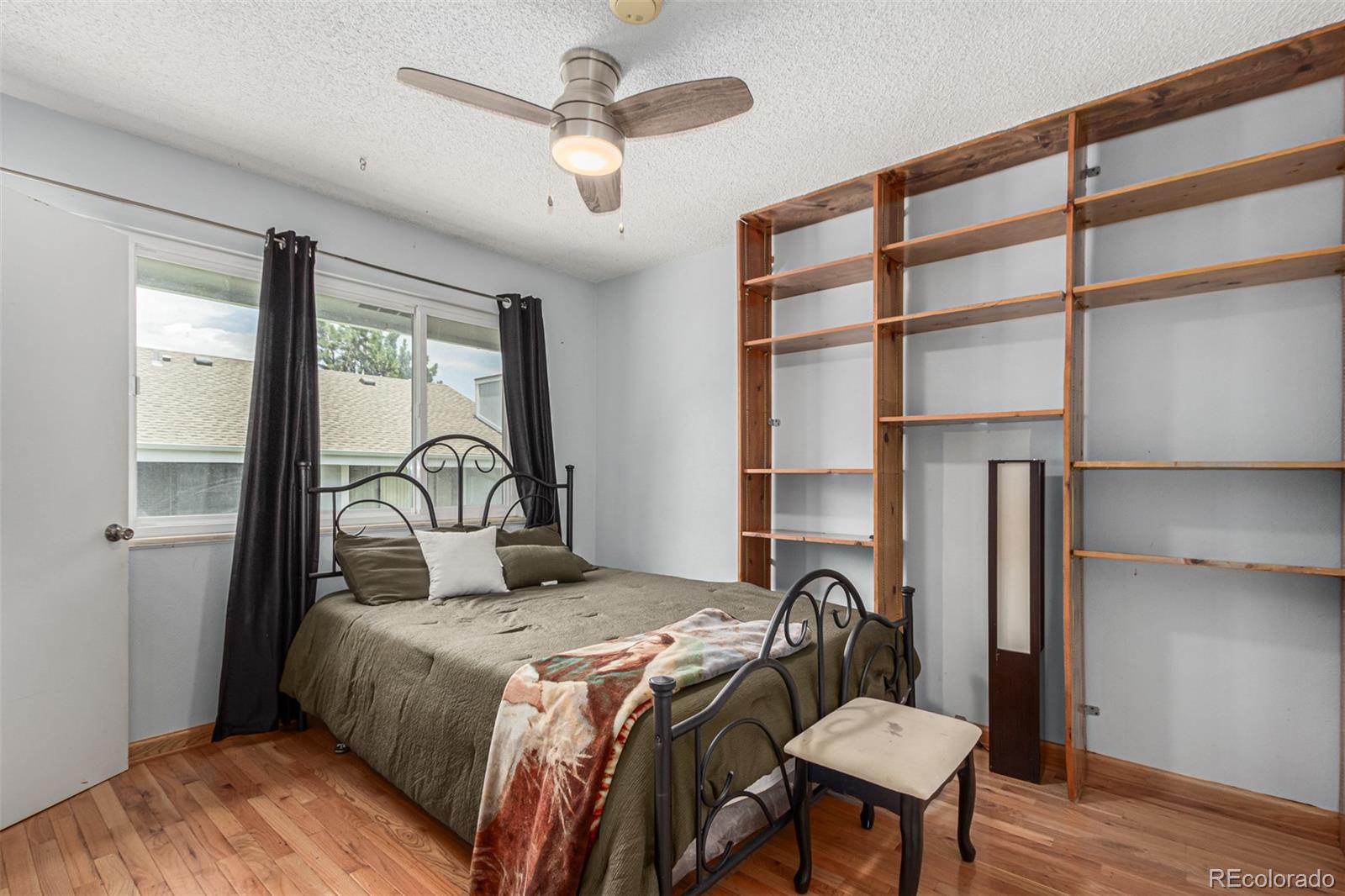 8140 West 90th Avenue Westminster, CO 80021 - Photo 21 of 47 a bedroom with a bed and a table in it