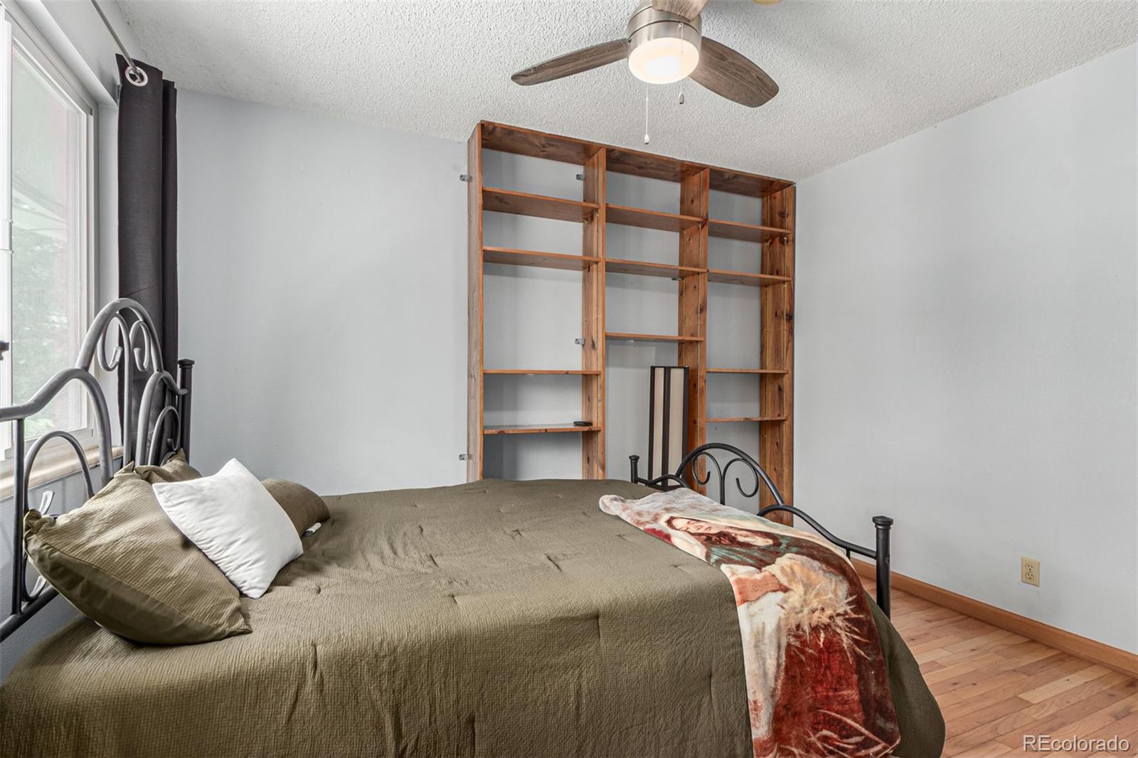 8140 West 90th Avenue Westminster, CO 80021 - Photo 23 of 47 a bedroom with a bed and a chandelier