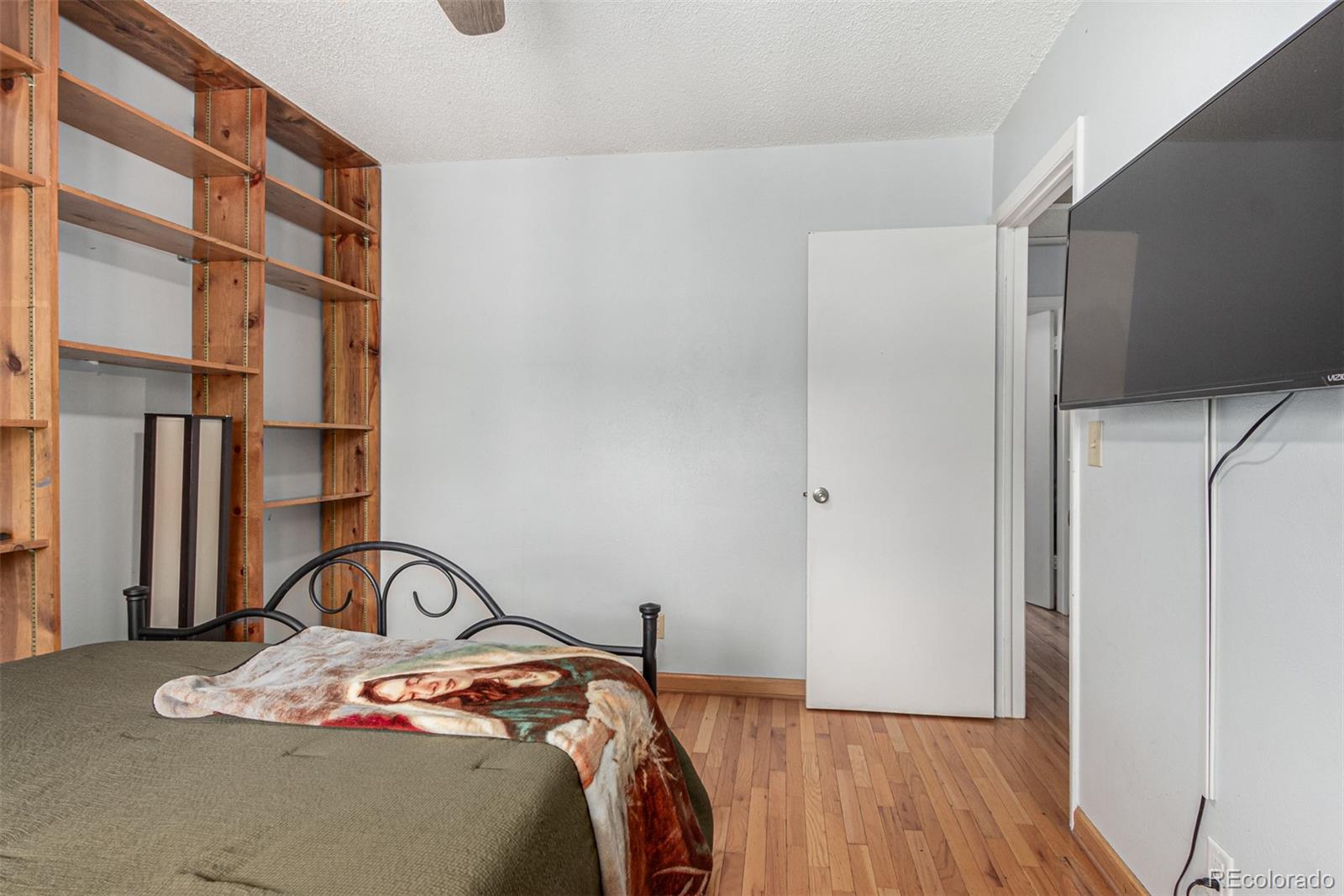 8140 West 90th Avenue Westminster, CO 80021 - Photo 24 of 47 a bedroom with a bed and a mirror