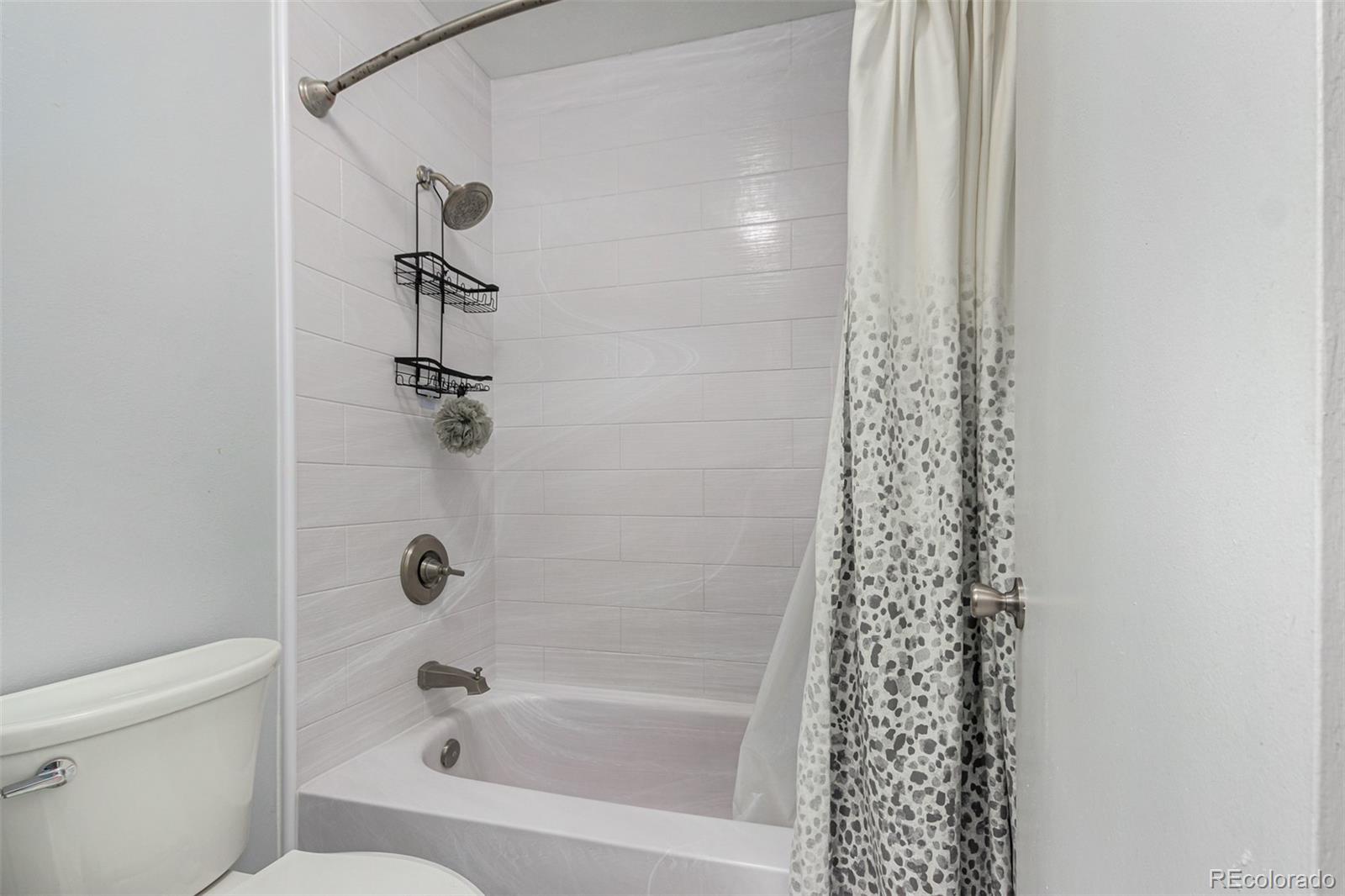 8140 West 90th Avenue Westminster, CO 80021 - Photo 27 of 47 a bathroom with a bathtub and shower