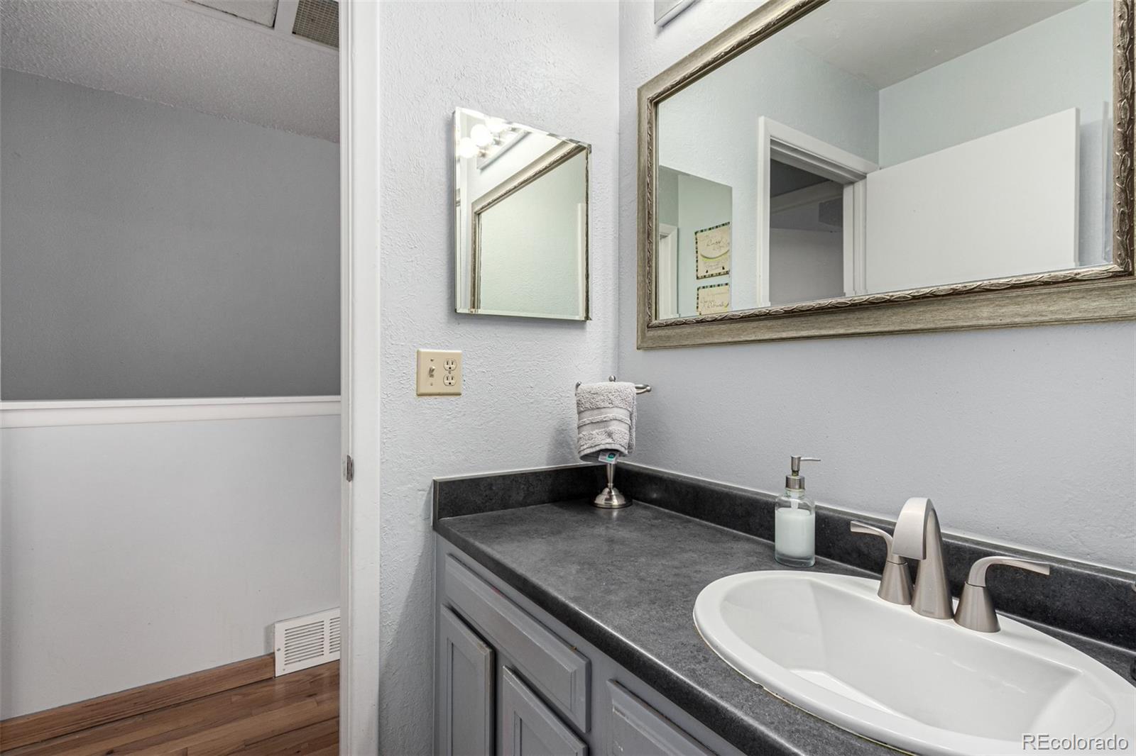 8140 West 90th Avenue Westminster, CO 80021 - Photo 28 of 47 a bathroom with a sink and a mirror