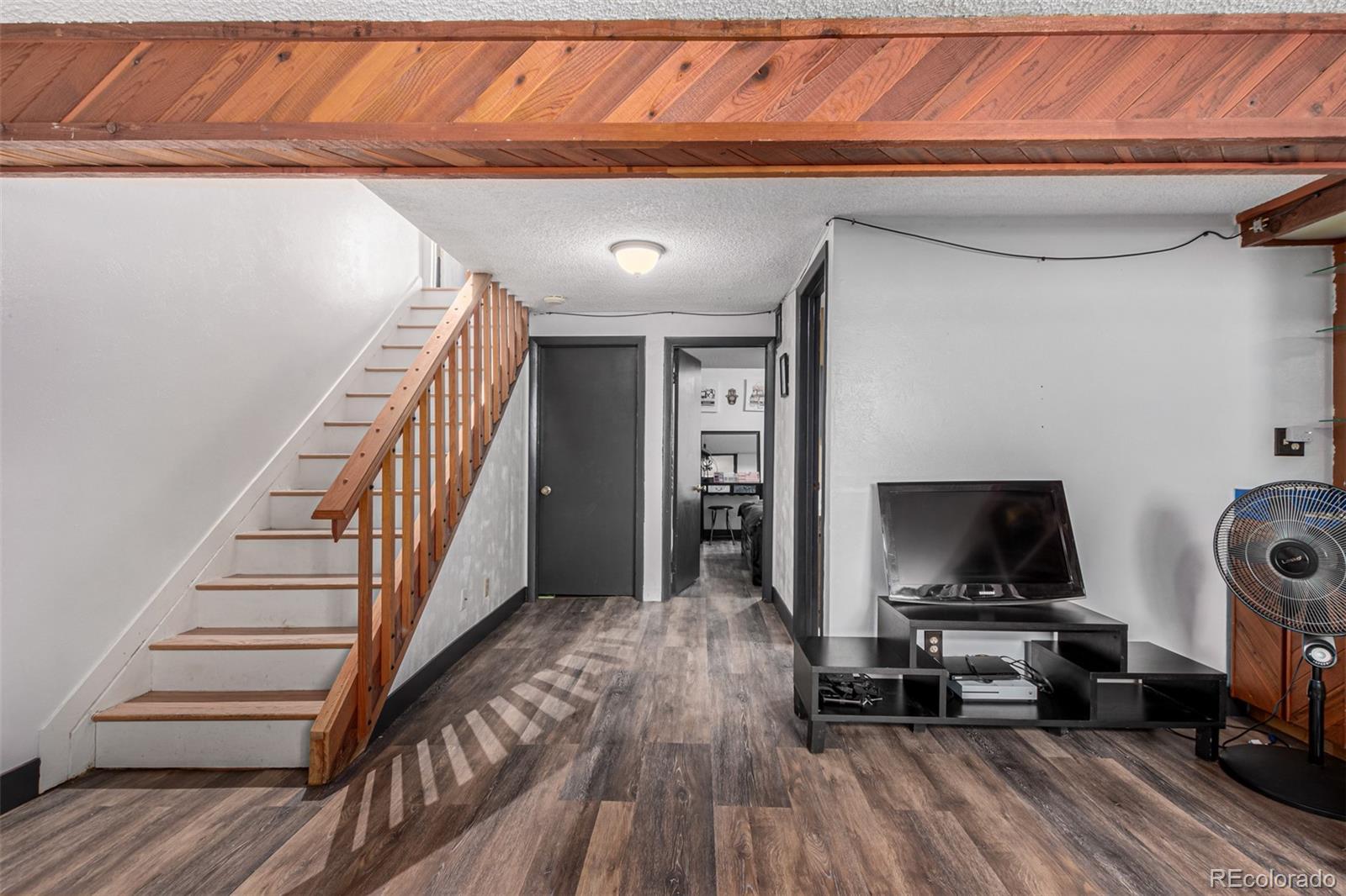 8140 West 90th Avenue Westminster, CO 80021 - Photo 29 of 47 a living room with furniture and a flat screen tv