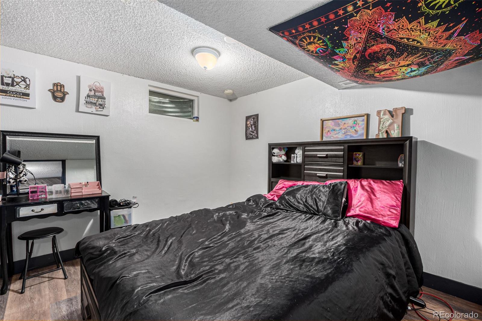 8140 West 90th Avenue Westminster, CO 80021 - Photo 34 of 47 a bedroom with a bed and a bookshelf