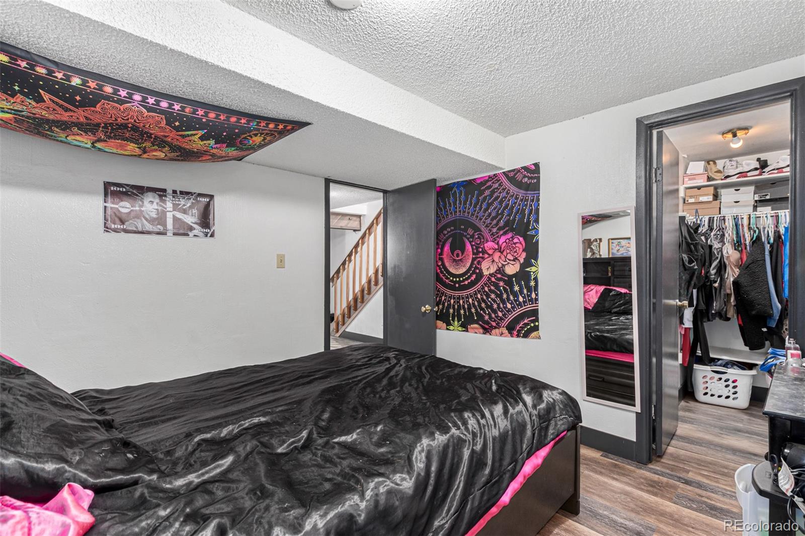 8140 West 90th Avenue Westminster, CO 80021 - Photo 36 of 47 a bedroom with bed and paintings on the wall