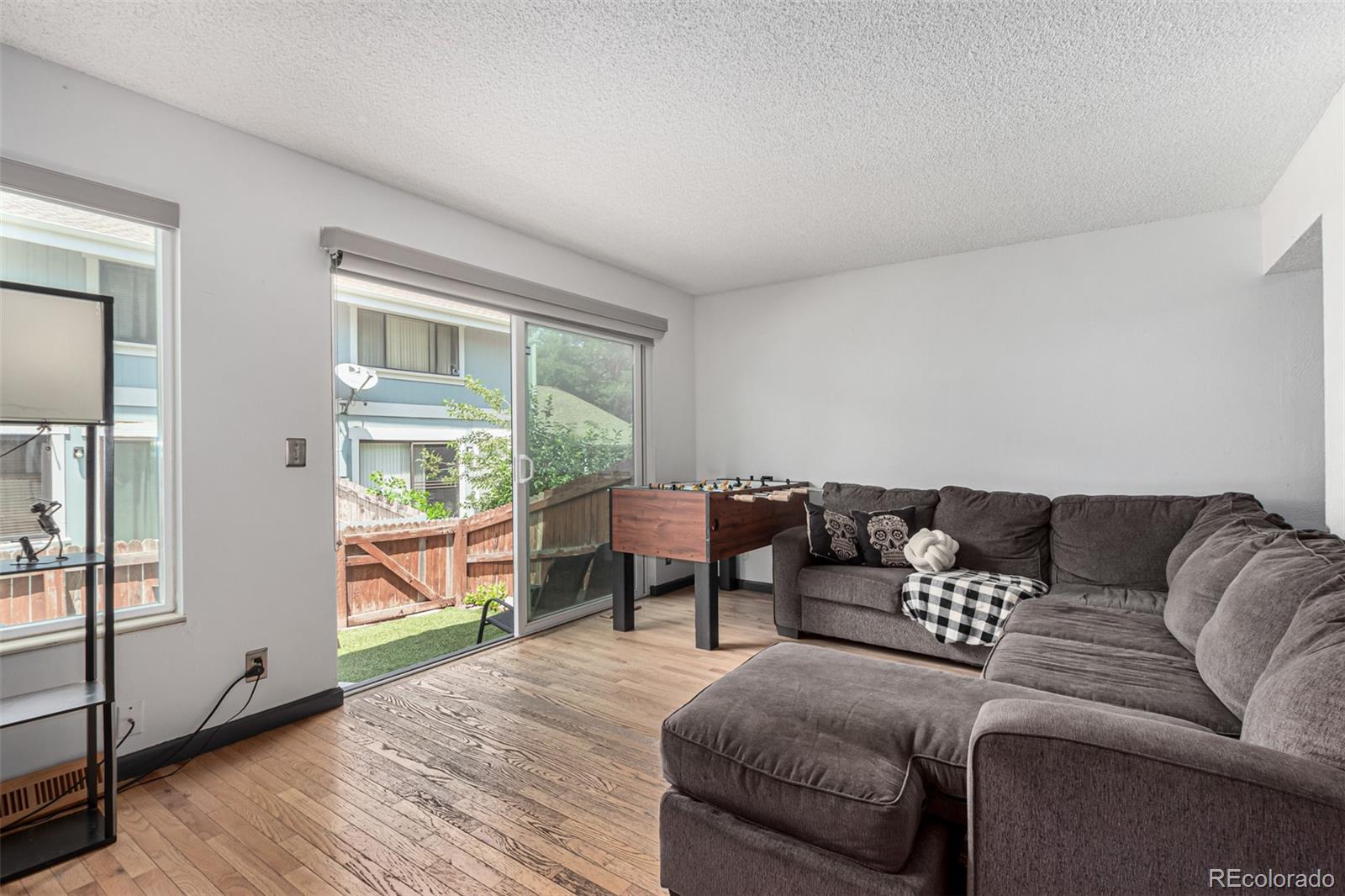8140 West 90th Avenue Westminster, CO 80021 - Photo 6 of 47 a living room with furniture and a large window
