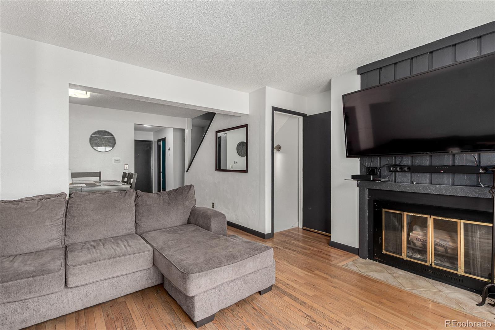 8140 West 90th Avenue Westminster, CO 80021 - Photo 7 of 47 a living room with furniture and a flat screen tv