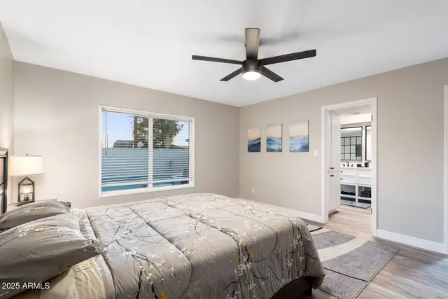 a bedroom with a large bed and a window