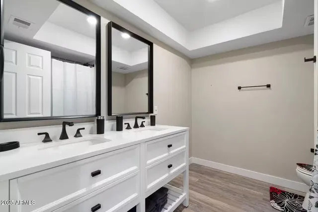 a bathroom with a double vanity sink and a mirror