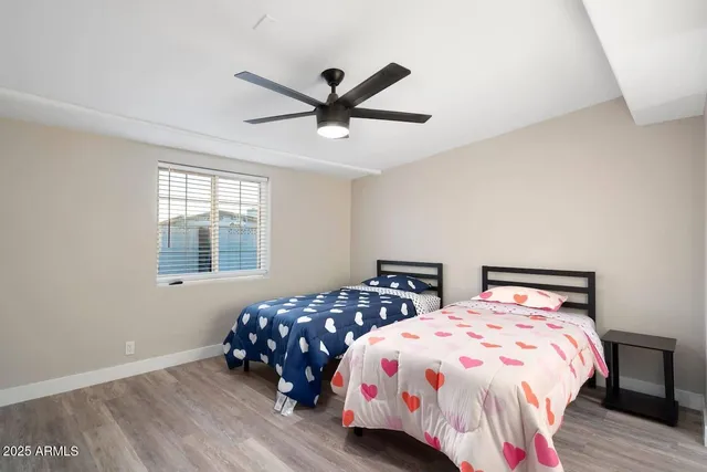 a bedroom with two beds and a window
