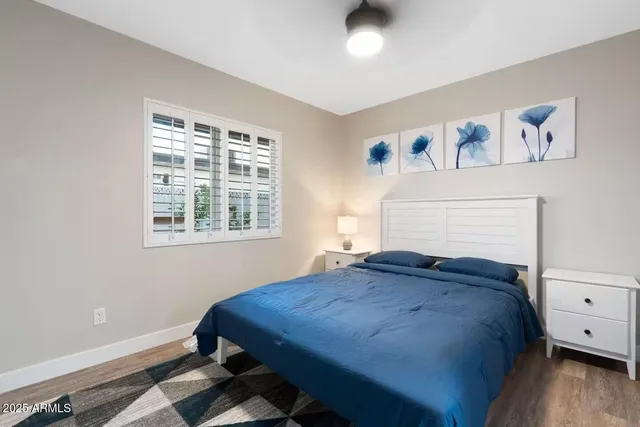 a bed sitting in a bedroom next to a window