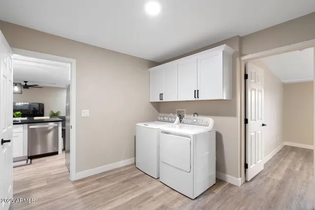 a kitchen with a sink cabinets and wooden floor