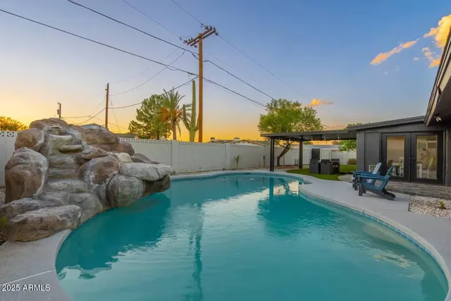 a backyard of a house with table and chairs