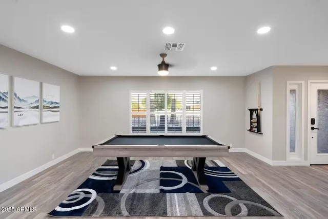 a kitchen with a stove and wooden floor