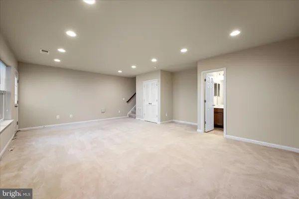 an empty room with closet and windows
