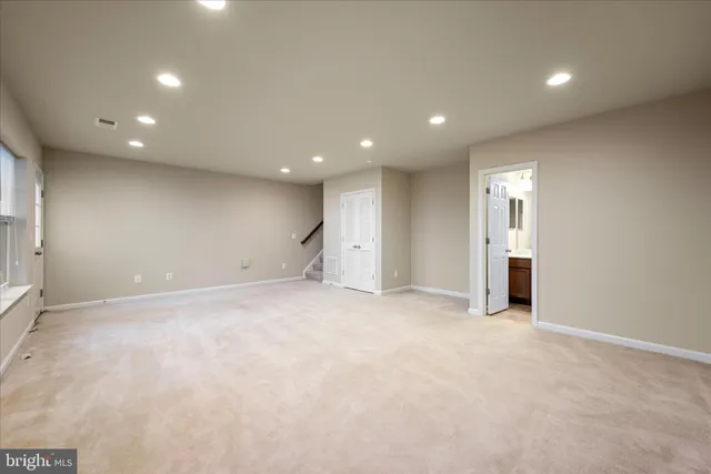 an empty room with closet and windows