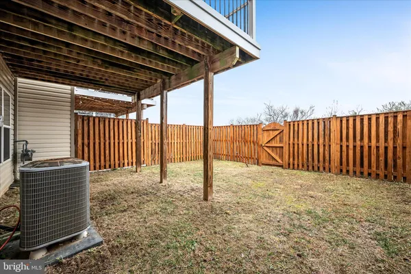 a view of a backyard with wooden fence