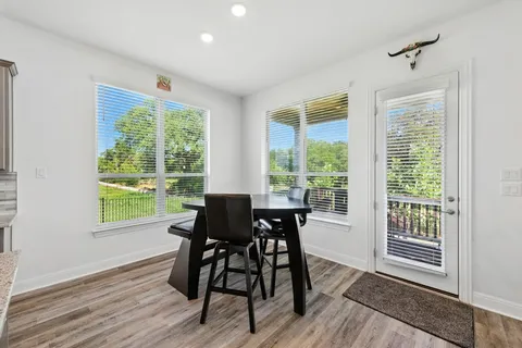 a view of a dining room with furniture and a window
