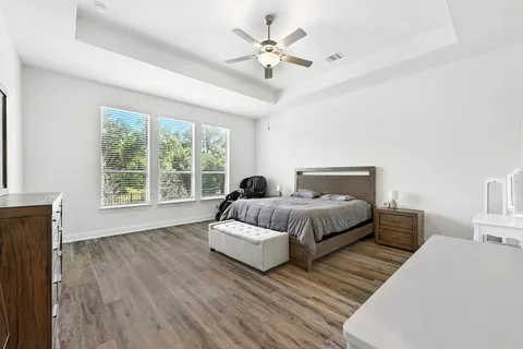 a spacious bedroom with a bed and a large window