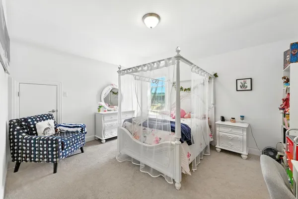 a bedroom with furniture and a window