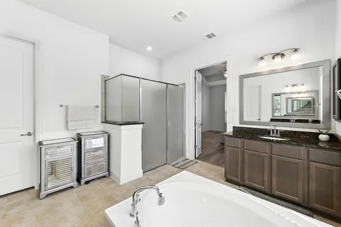a large bathroom with a double vanity sink a and a mirror