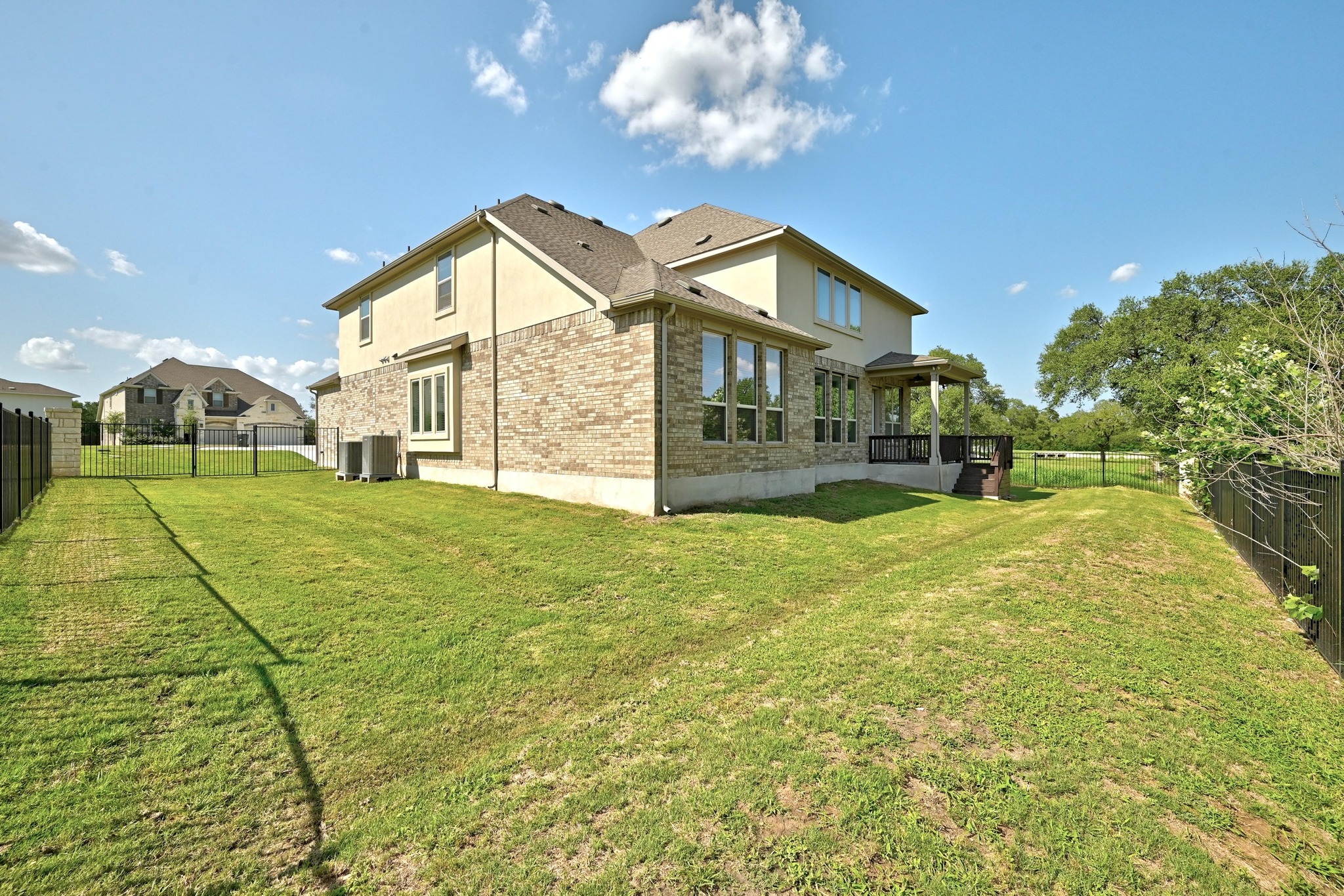 216 Tovas Secret Cove Georgetown, TX 78628 - Photo 37 of 39 Back of property featuring a fenced backyard, brick siding, and stucco siding