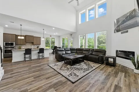 a living room with furniture and a wooden floor