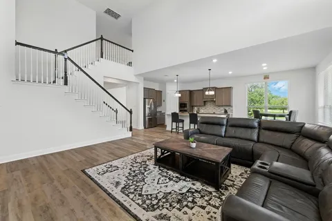 a living room with furniture and wooden floor