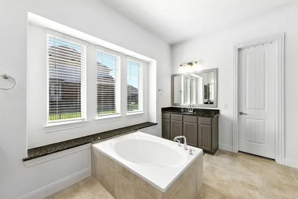 a large white kitchen with a large window