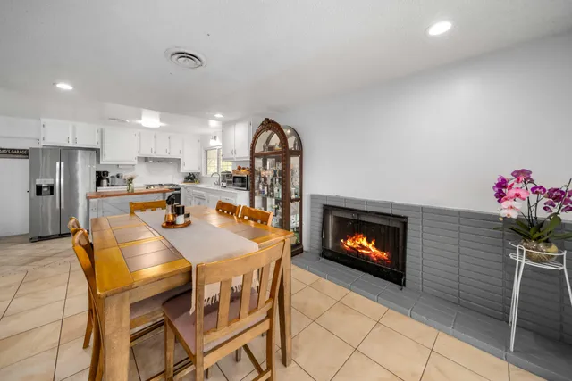 a kitchen with a table chairs and a refrigerator