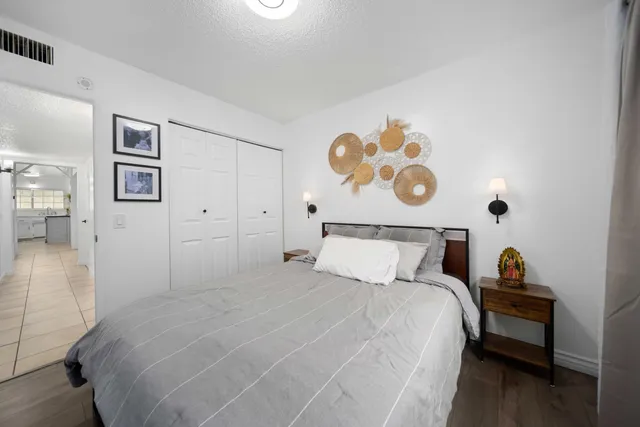 a bedroom with a bed and painting on the wall