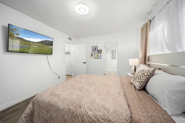 a bedroom with a bed and a window