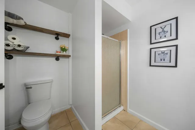 a bathroom with a toilet and a shower