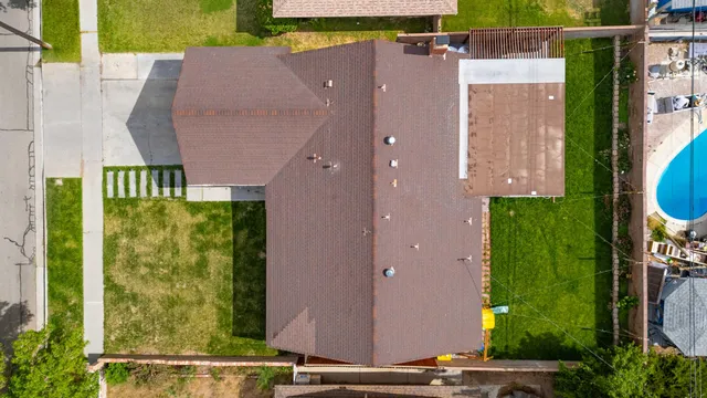 an aerial view of residential houses with outdoor space and street view