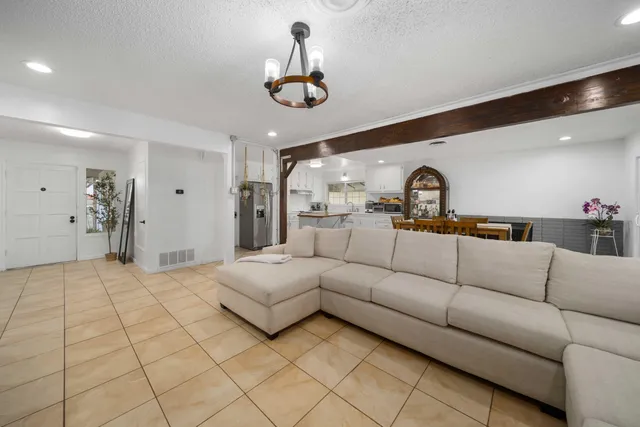 a living room with furniture and a chandelier