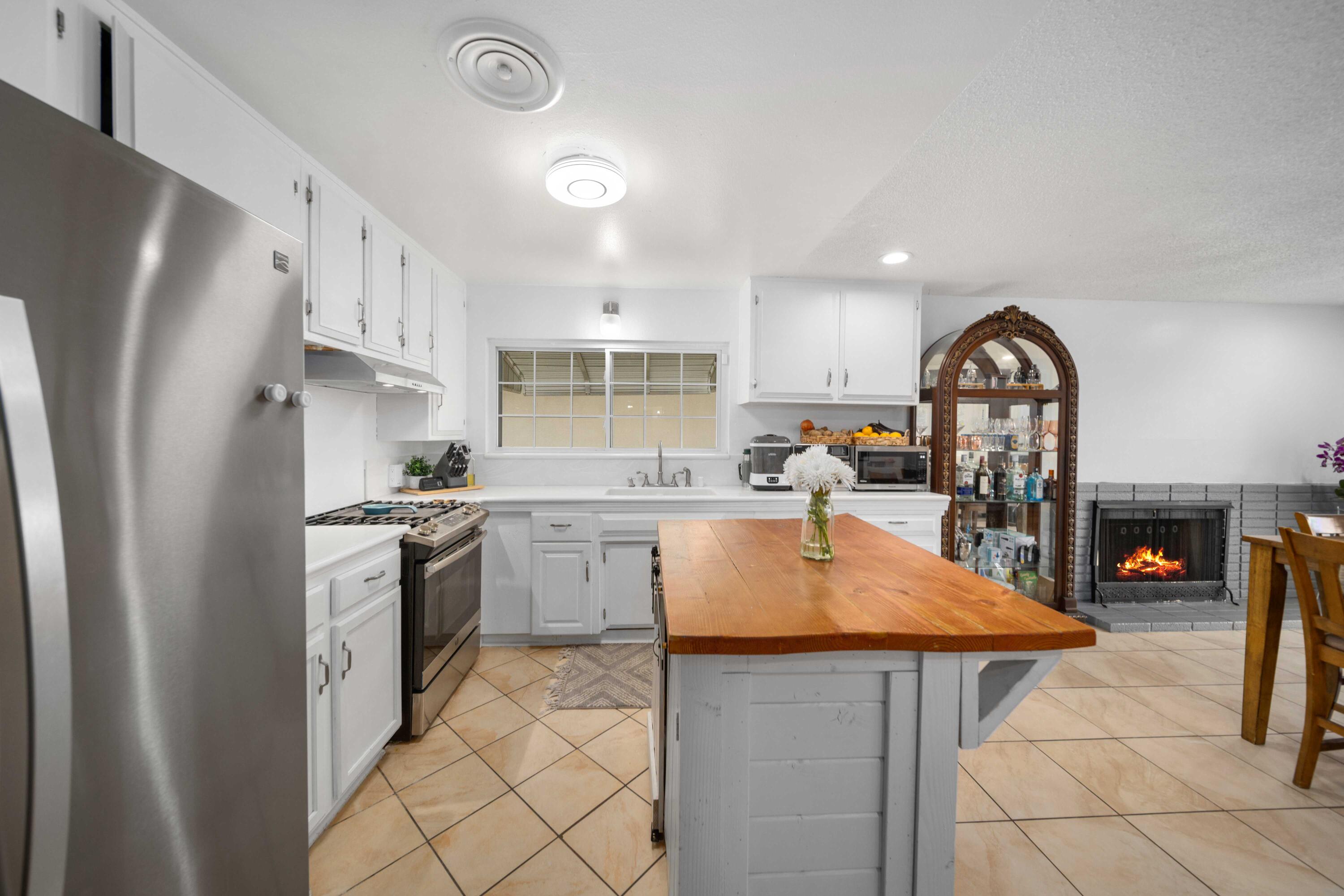 45339 Saigon Avenue Lancaster, CA 93534 - Photo 8 of 28 a kitchen with stainless steel appliances granite countertop a stove refrigerator sink and cabinets