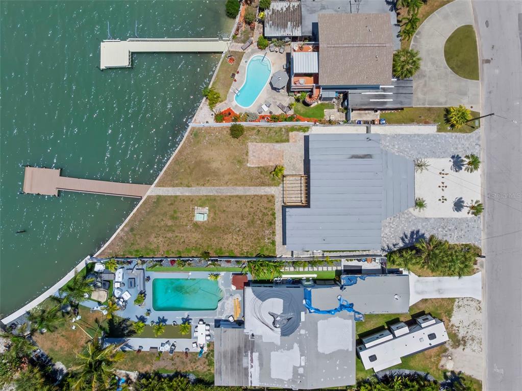 708 Sunset Cove Madeira Beach, FL 33708 - Photo 54 of 61 an aerial view of a house with a yard and lake view