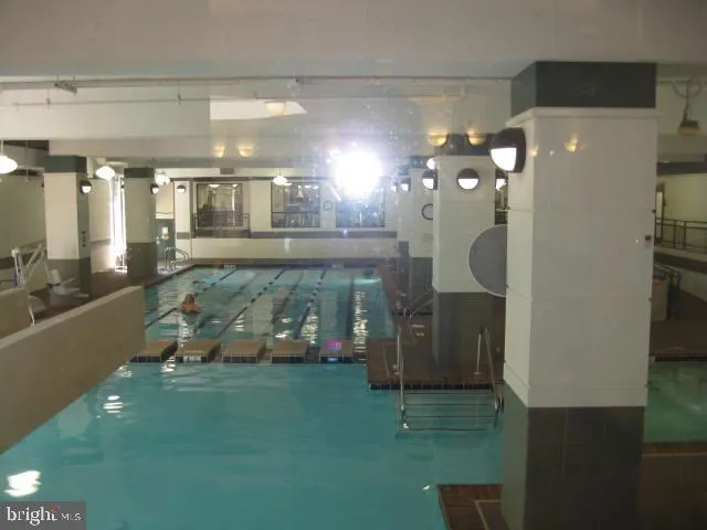 a bathroom with a sink a large mirror and a shower