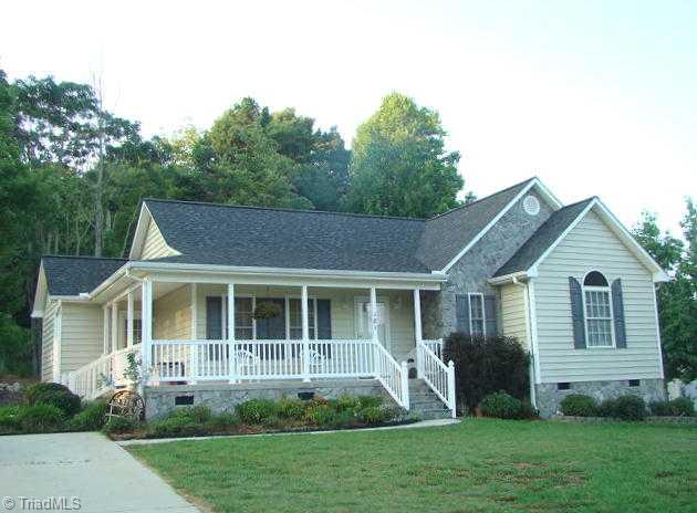 Exterior Front. Paved driveway, wrap around front porch.