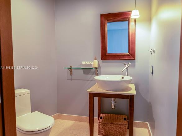 450 Alton Road, Unit 1202 Miami Beach, FL 33139 - Photo 28 of 68 a bathroom with a sink a toilet and mirror